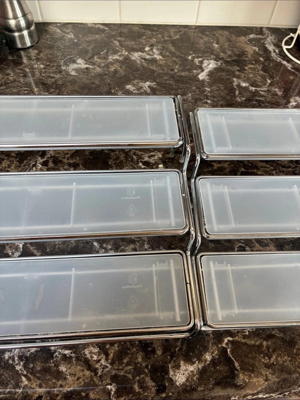 Clear plastic & metal display shelves slide together